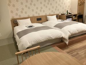 a rendering of a bedroom with a large bed at Tokyo Inn in Tokyo
