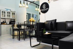 a living room with black furniture and a table at Caryolba hometel - Calapan in Calapan