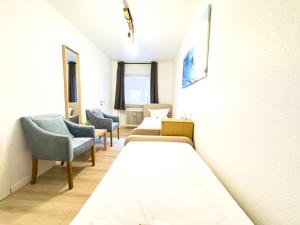 a hospital room with two beds and chairs at Business Apartment Altstadt in Bremen