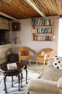 a living room with a couch and a table and chairs at Ou Werf Farm Cottage in Bredasdorp