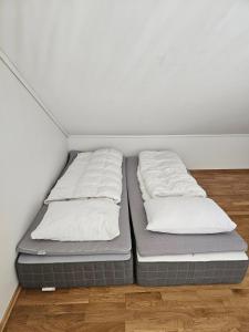 two beds sitting in a corner of a room at Mountain view 2 in Håra