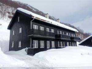 a large black building with snow on top of it at Mountain view 2 in Håra +19 photos