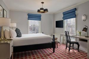 a bedroom with a bed and a desk and a chair at Morrison House Old Town Alexandria, Autograph Collection in Alexandria +26 photos