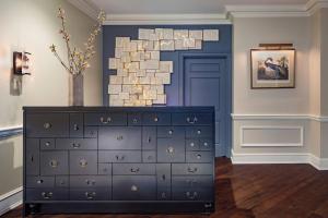 a black dresser in a room with a blue door at Morrison House Old Town Alexandria, Autograph Collection in Alexandria