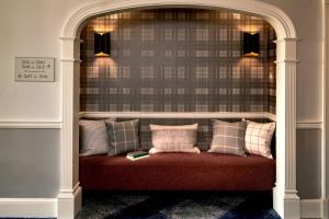 a bench with pillows on it in a room at Morrison House Old Town Alexandria, Autograph Collection in Alexandria