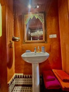 a bathroom with a sink and a mirror at Dar Tagore in Fez +133 photos