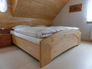 a bedroom with a wooden bed in a attic at Apartment Herbert Panter in Bad Peterstal-Griesbach
