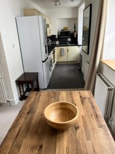 a wooden bowl on a wooden table in a kitchen at 2 smw in Peebles