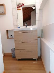 a bathroom with a sink and a mirror at Gîte Le Wallis in Le Sappey-en-Chartreuse +13 photos