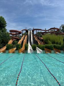 a large swimming pool with a water slide at Villa Chiusagrande in Campiglia Marittima