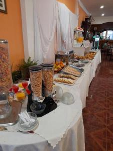a long white table with food on it at Departamentos Anthony in Santa Teresita +6 photos