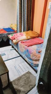 a room with two bunk beds in a room at Lokbhgwat house in Jhūsi
