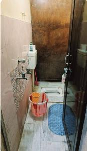 a bathroom with a toilet and a sink and a shower at Lokbhgwat house in Jhūsi