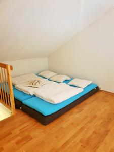 a bed in a room with a wooden floor at Mountain view 1 in Håra