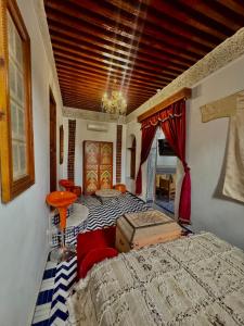 a bedroom with a bed and a room with a couch at Dar Tagore in Fez