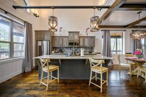 a kitchen with a large island in the middle of a room at Magnolia Peak By The Cohost Company in Broken Bow