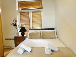 a bedroom with a bed with two slippers on it at Cosy Flat at Temple Bar Dublin in Dublin