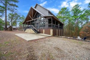 a large house on top of a gravel field at Magnolia Peak By The Cohost Company in Broken Bow
