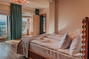 a bedroom with a large bed with green curtains at Mountain Diamond Resort in Zakopane +95 photos