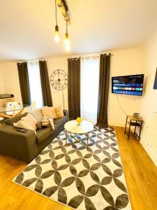 a living room with a couch and a table at Southampton Haven in Southampton