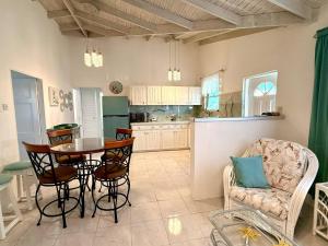 a kitchen and dining room with a table and chairs at ZenBreak Steps to the Sea 3Bd in Saint Peter