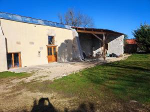 a shadow of a person standing in front of a building at La tourterelle in Cayriech