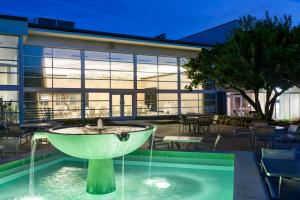 a fountain in the middle of a pool in front of a building at South Sioux City Marriott Riverfront in South Sioux City