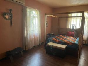 a bedroom with a bed and a window at Calodyne Villa in Calodyne +9 photos