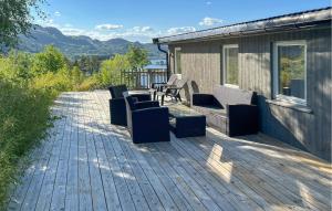 a deck with chairs and a table on a house at 5 Bedroom Pet Friendly Home In Eiken in Eiken +17 photos