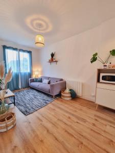 a living room with a couch and a table at Opaline - centre-ville in Pontivy