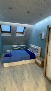 a bedroom with a bed and two chairs in it at Sunny & Stylish Apartment in Vratsa