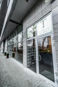 a store front with glass doors on a building at Triton Park Apartments in Warsaw