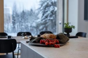 a plate of food on a table with vegetables at Joikun Lumo by Hi Ylläs in Äkäslompolo