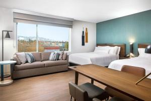 a hotel room with two beds and a couch at Element by Marriott Reno Experience District in Reno +68 photos