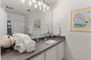 a white bathroom with a sink and a mirror at SeaHaven, Unit 1529 - 1529 Wood Ave in East End +16 photos