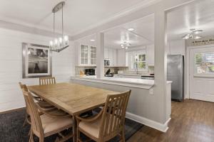 a kitchen and dining room with a wooden table and chairs at SeaHaven, Unit 1529 - 1529 Wood Ave in East End