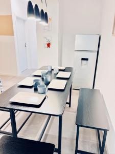 a dining room with a table and chairs and a refrigerator at CLUBHAUS 6 - geräumige Ferienwohnung mit 4 Schlafzimmern & 2 Bädern in Worbis