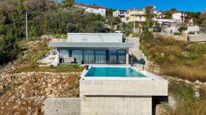 a house on a hill with a swimming pool at Villa Sea level with BEAUTIFUL VIEW, Medveja in Lovran