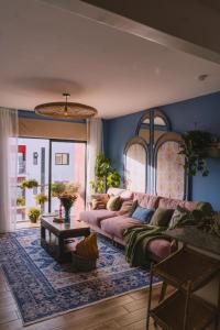 a living room with a pink couch and a table at Tatu City Two Bedroom Apartment in Tatu City