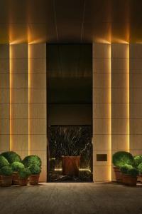 a building with potted plants in front of it at The Tokyo EDITION, Toranomon in Tokyo +56 photos