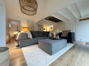 a living room with a couch and a table at Duinstudio Bergen in Bergen