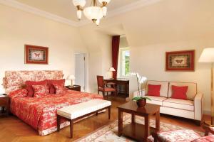 a bedroom with a bed and a couch at Villa Rothschild, Autograph Collection in Königstein im Taunus