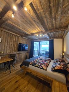 a bedroom with a bed and a wooden ceiling at Corso Harrachov Apartment 303 in Harrachov +17 photos