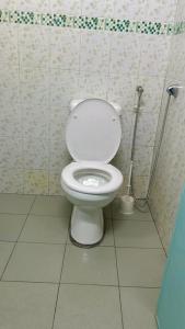 a bathroom with a white toilet in a stall at Homestay Semenyih Hakim in Semenyih