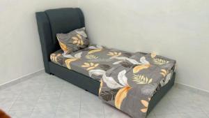 a bed sitting in a corner of a room at Homestay Semenyih Hakim in Semenyih