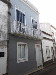 a building with a balcony on the side of it at Vila Nova Suite Apt (historic PDL city center) in Ponta Delgada