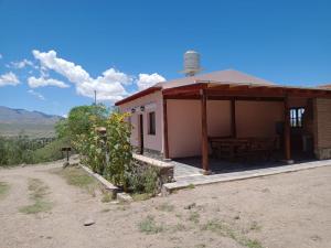 a small house with a picnic table in front of it at Casa DE CAMPO SUMAQ WASI in Cachí