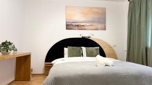 a bedroom with a large bed with a black headboard at Felix 41 - Piata Victoriei, Near Metro - RH Living in Bucharest