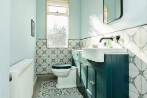 a bathroom with a toilet and a sink at The Prince's Eyrie - Spacious, comfy and cosy in Bishop Auckland +10 photos