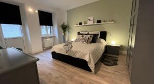 a bedroom with a bed and two lamps on a wooden floor at Your Porto Home Lake Mountain in Porto Ceresio